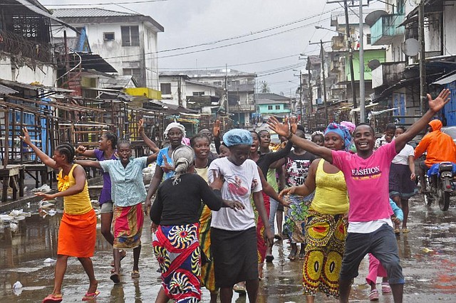 People celebrate the reopening of the West Point slum area of Monrovia, Liberia. The slum had been quarantined by security forces in a bid to control the spread of Ebola.