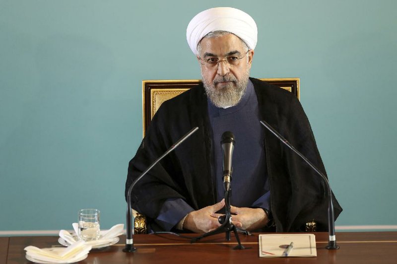 Iranian President Hassan Rouhani reacts Saturday in Tehran to Western sanctions over Iran’s nuclear program.