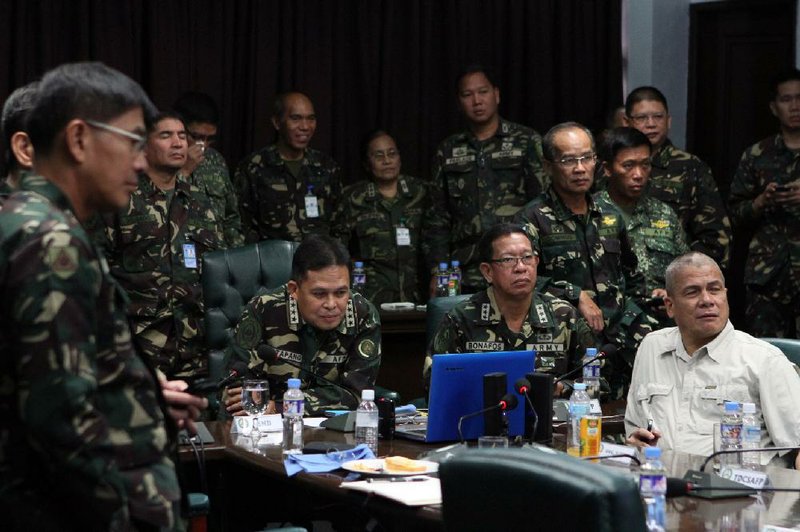 Philippines military chief Gen. Gregorio Pio Catapang Jr. (seated left) holds an online videoconference Saturday with a commander of Philippine troops at one of the encampments in the Golan Heights. The troops came under attack by Syrian rebels early Saturday, the U.N. said, adding that all 35 of the Philippine peacekeepers at the Breiqa encampment were accounted for and safe.