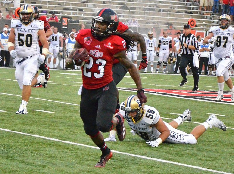 Arkansas State’s J.D. McKissic (23) runs away from Montana State’s Rhett Young in the second quarter of the Red Wolves’ 37-10 victory Saturday at Centennial Bank Stadium in Jonesboro.