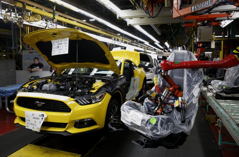 A seat is set to be installed on a 2015 Ford Mustang at an assembly plant in Flat Rock, Mich. Ford is seeking overseas appeal for the car in 2015.