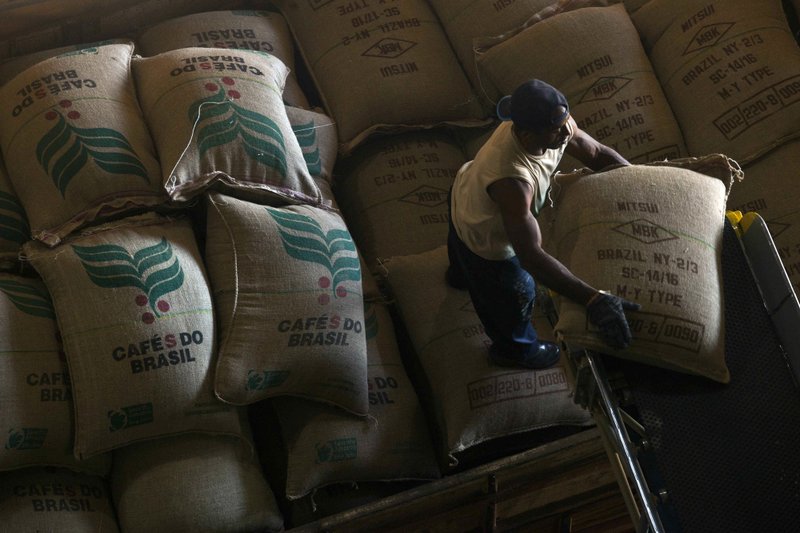 Bags of coffee beans for export are loaded onto a truck at a cooperative’s grain complex in Minas Gerais state, Brazil, in 2013. Brazil’s coffee harvest this year may drop as much as 18 percent, the National Coffee Council estimates.