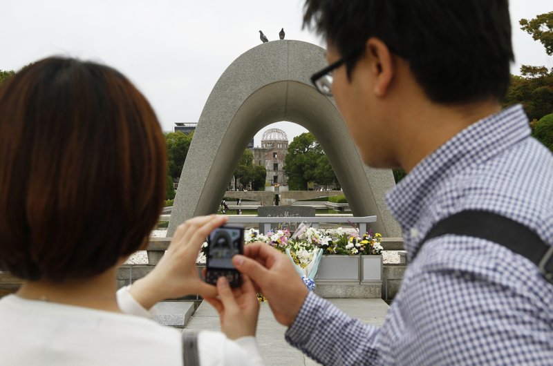 Getty Images A couple takes photos of the Atomic Bomb Dome at Hiroshima Peace Memorial Park. The structure, built in 1917, still stood after the Hiroshima atomic bomb blast in 1945 and has become a part of the city&#8217;s remembrance.