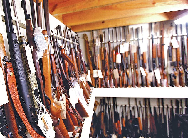 STAFF PHOTO JASON IVESTER Guns are stored in an evidence room Friday at the Benton County Sheriff&#8217;s Office in Bentonville.