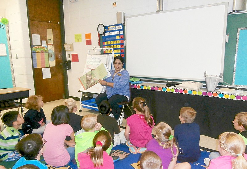 Submitted photo Reading introduction: Lake Hamilton Elementary School's new reading interventionist, Sandra Slicko, reads a short story to third-grade students. Slicko spent the first two weeks of school visiting every classroom and reading to students.