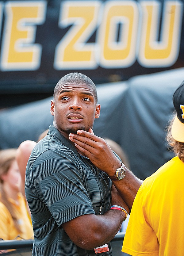 The Associated Press LOOKING FOR WORK: Michael Sam watches pregame festivities before the start of the South Dakota State-Missouri game Saturday in Columbia, Mo. Sam, who played at Missouri and is the first openly gay player drafted by an NFL team, was released by the St. Louis Rams.