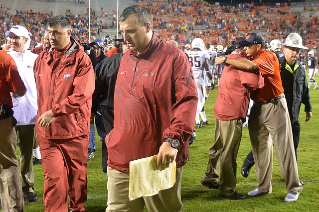 Arkansas coach Bret Bielema heads off the field after the Razorbacks' 45-21 loss to Auburn Saturday, Aug. 30, 2014, at Jordan-Hare Stadium in Auburn.