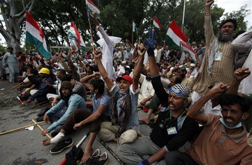 Supporters of anti-government Muslim cleric Tahir-ul-Qadri chant slogans as they stage a sit in protest close to Prime Minister's home in Islamabad, Pakistan on Monday, Sept. 1, 2014. Anti-government protesters and Pakistani police have clashed once again as the demonstrators pushed into a sprawling government complex in the country's capital in an effort to try to reach the prime minister's official residence. 