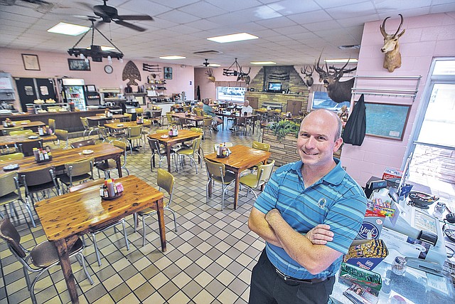 STAFF PHOTO ANTHONY REYES &#8226; @NWATONYR Micah Neal, owner of Neal&#8217;s Cafe, stands Thursday at the cafe in between the breakfast and lunch rush in Springdale. Neal&#8217;s is turning 70 this year. Neal&#8217;s, great-grandparents, Toy and Bertha Neal, founded the cafe in 1944. He&#8217;s the fourth generation of the family to run the business and political go-to stop for politicians, city and county leaders.