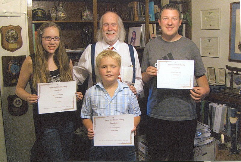 Submitted photo Byron Cole Rhodes Family Foundation is again sponsoring the &#8220;Why Garland County is a Great Place to Live&#8221; awards at the county fair. The first place winner will receive a $100 savings bond, second place, a $50 savings bond, and third place, a $25 savings bond. Rhodes is pictured with last year&#8217;s winners, Compassion Deloach, left, Carson Redmon, and Nic Armand. This year&#8217;s fair is scheduled for Sept. 8-13.