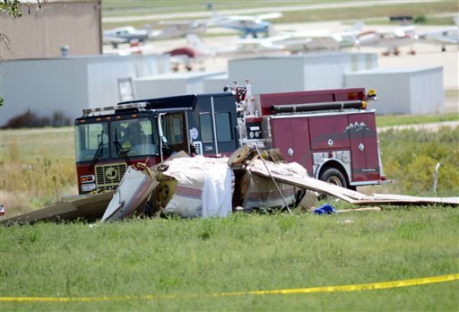 Firefighters work on the scene where three people were killed and two others injured after an airplane crashed in a field northwest of the main runway at Erie Municipal Airport while coming in for a landing in Erie, Colo., Sunday, Aug. 31, 2014. 