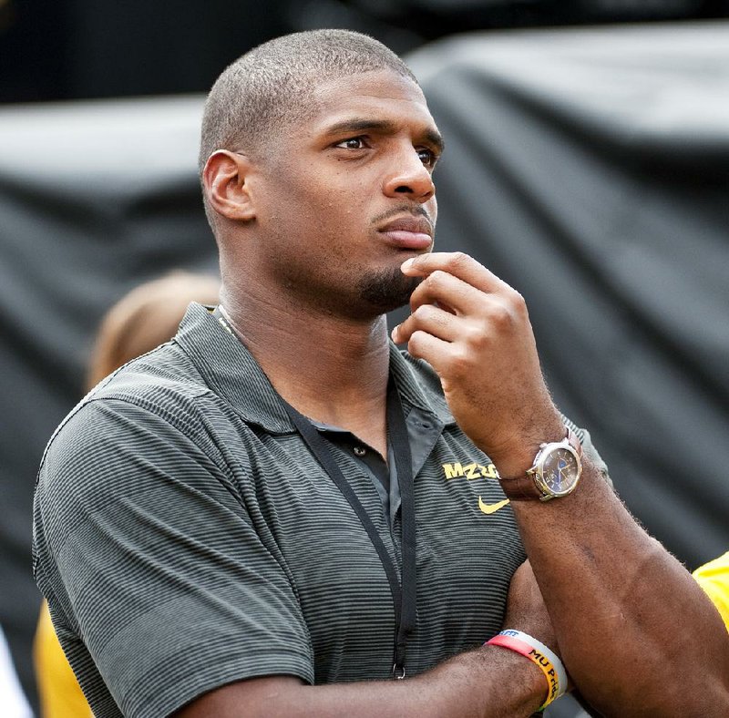 Former Missouri player Michael Sam watches pregame festivities before the start of the South Dakota State-Missouri NCAA college football game Saturday, Aug. 30, 2014, in Columbia, Mo. The St. Louis Rams cut Michael Sam, the first openly gay player drafted by an NFL team. Coach Jeff Fisher repeated over and over that it was purely a football decision. (AP Photo/L.G. Patterson)