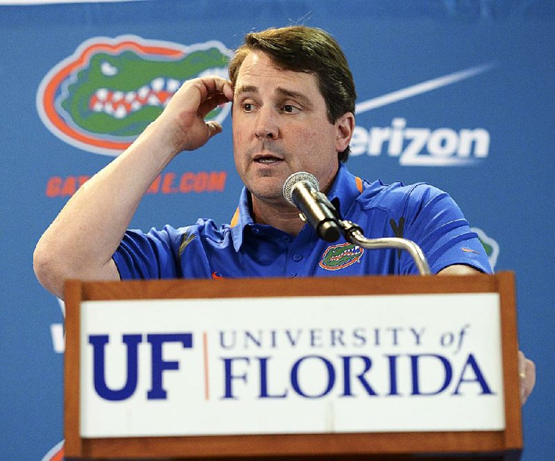 FILE - In this Aug, 3, 2014, file photo, Florida head football coach Will Muschamp fields questions from the media during an NCAA college football Media Day, in Gainesville, Fla. Coaches often say they are always on the hot seat. That might be true, but some seats are hotter than others. A few coaches in high-profile positions heading into 2014 very much in need of winning records and quality victories. (AP Photo/Phil Sandlin, File)