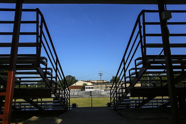 8/20/14
Arkansas Democrat-Gazette/STEPHEN B. THORNTON
UALR's Benton Center, background center, is framed by the stands at CW Lewis Stadium in Benton Wednesday morning. Benton Mayor David Mattingly announces a contract with UALR to rebuild CW Lewis Stadium for the city's parks department.