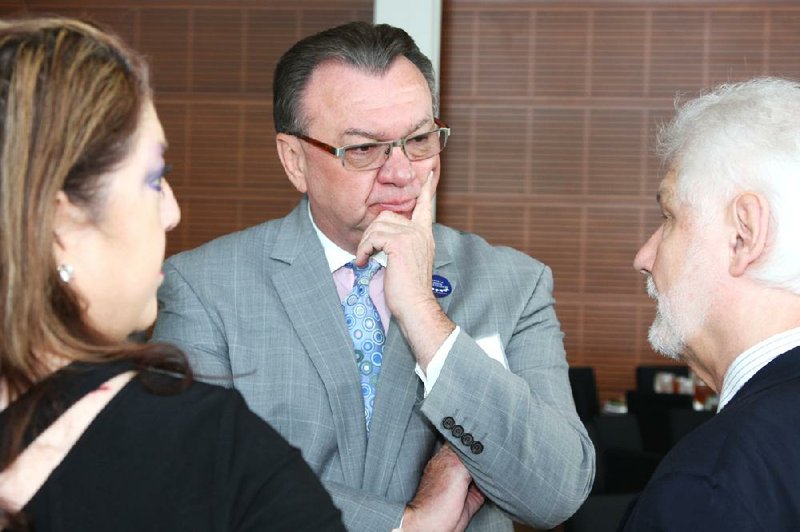 UALR Athletic Director Chris Peterson (center), who arrived at the school in 2000, submitted his resignation Tuesday after a summer of turmoil involving the Trojans’ athletic program.