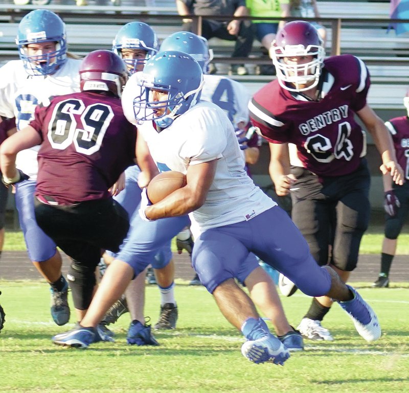 Allan Castaneda moves the ball downfield during scrimmage play between Gentry and Decatur on Thursday.