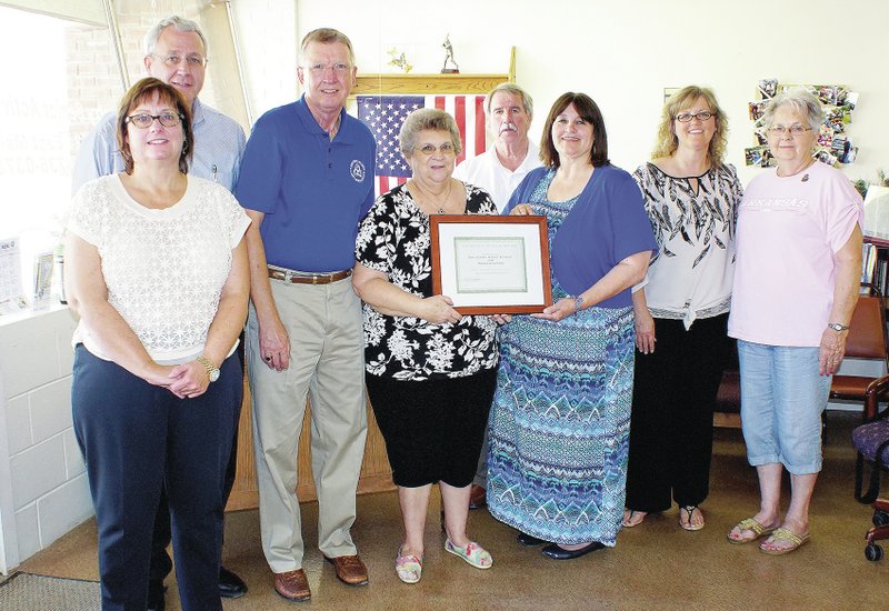 Photo by Randy Moll Gentry Senior Activity Center received its certification as a wellness center on Aug. 26. Present for the occasion were Susan Moore, executive director of the Office of Human Concern; Tim Ensley, director of operations for the Office of Human Concern; Jerry Mitchell, executive director for the Area Agency on Aging of Northwest Arkansas; Jackie Bader, manager of the Gentry center; Beverly Dunlap, Arkansas Department of Human Services (presenting the certificate to Bader); Tom Hough, director of senior services for OHC; Angie Dunlap, director of senior center services for the Area Agency on Aging; and Maxine Foster, local resident and member of GSAC.