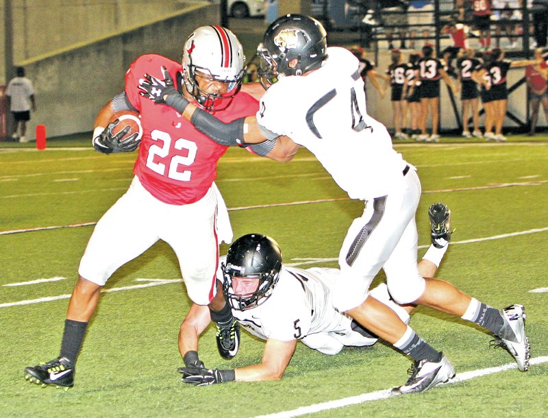  File Photo Bentonville defenders tackle a Tulsa Union runner during the Gridiron Classic football preview at Tulsa Union on Thursday.