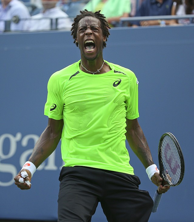 Gael Monfils, of France, reacts after a shot against Grigor Dimitrov, of Bulgaria, during the fourth round of the 2014 U.S. Open tennis tournament, Tuesday, Sept. 2, 2014, in New York.