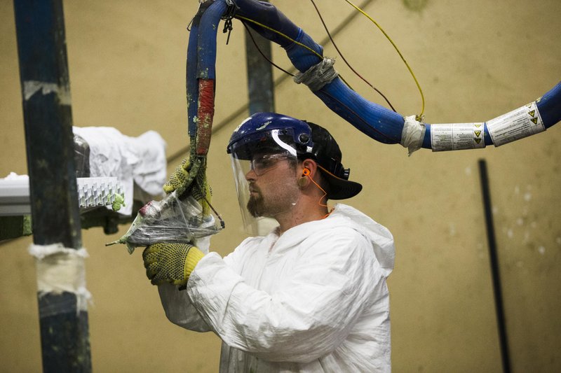 In this Aug. 7, 2014 photo, a worker assembles construction supplies at Northeast Building Products in Philadelphia. The Institute for Supply Management, a trade group of purchasing managers, issues its index of manufacturing activity for August on Tuesday, Sept. 2, 2014.