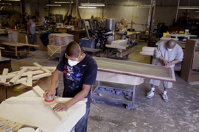 Employees work at the Northland Furniture Co. factory in Bend, Ore., in July. Orders for U.S. factory goods rose by a record amount in July, mostly because of a jump in orders for commercial jetliners.