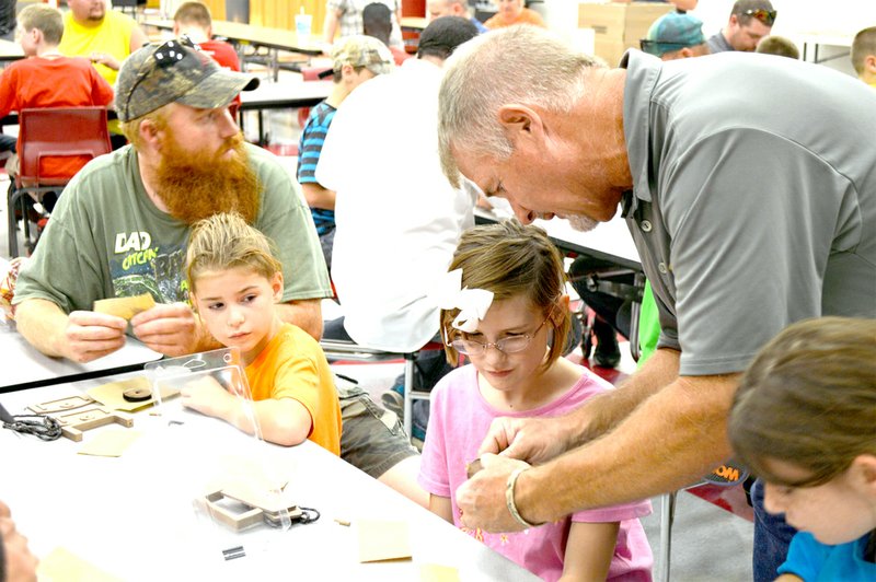 COURTESY PHOTO Local youth get personal instructions how to assemble and use their own deer call from Brad Harris, world champion game caller. Thirty youth attended the recent seminar hosted by Young Outdoorsmen United.