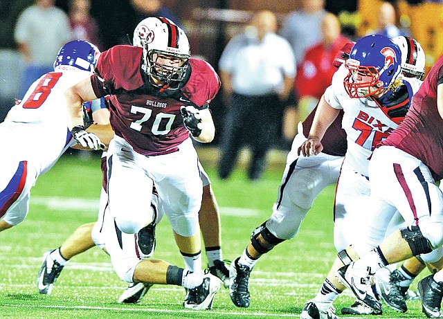 FILE PHOTO ANTHONY REYES Adam Thompson, center, of Springdale High maneuvers Sept. 20 against Bixby, Okla., at Jarrell Williams Bulldog Stadium in Springdale.