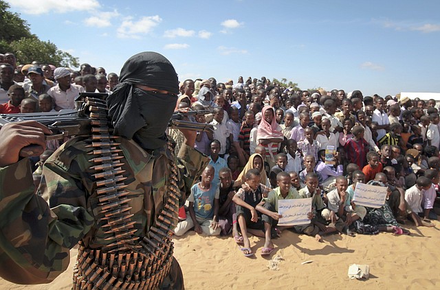 In this Feb. 13, 2012 file photo, an armed member of the militant group al-Shabab attends a rally in support of the merger of the Somali militant group al-Shabab with al-Qaida, on the outskirts of Mogadishu, Somalia. U.S. military forces targeted the Islamic extremist al-Shabab network in an operation Monday, Sept. 1, 2014 in Somalia, the Pentagon said.