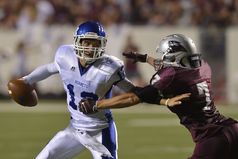 Bryant quarterback Brandan Warner (left) tries to evade a Benton defender during last year’s Salt Bowl. Warner, who led the Hornets to a 42-28 victory in the game, returns this season with the hopes of leading Bryant to its ninth consecutive victory in the series Friday night.