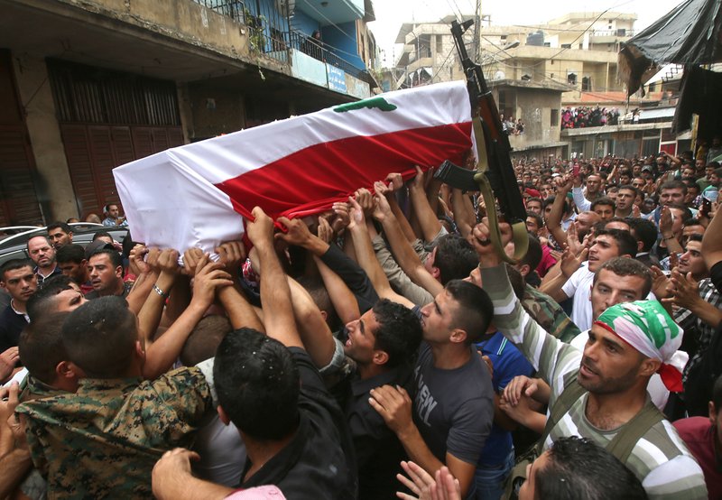 Lebanese Sunnis march Wednesday with the coffin of Sgt. Ali Sayid, 29, who was beheaded by Islamic militants, during a funeral Wednesday in his hometown of Fnaydek in northern Lebanon.