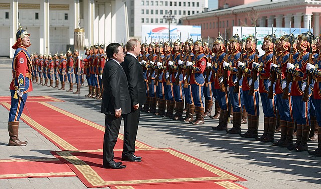 President Elbegdorj Tsakhia (left) of Mongolia and Russian President Vladimir Putin review the troops Wednesday at Genghis Khan Square in Ulan Bator.