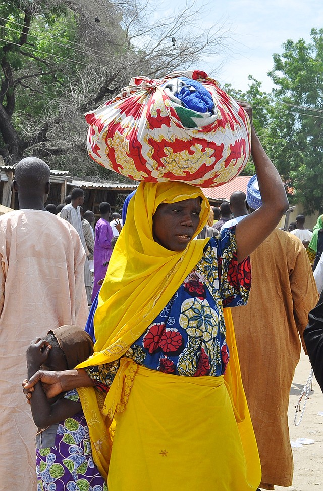 A woman and her daughter arrive Wednesday to seek refuge at a school in Maiduguri, Nigeria, after fleeing Islamic militants who attacked their home city of Bama in northeastern Nigeria.