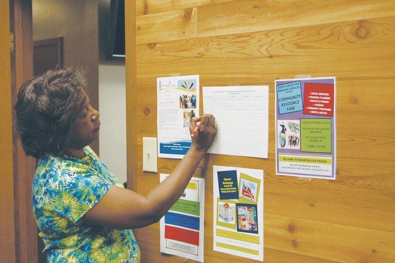 Johnnie Mitchell, a career counselor at College of the Ouachitas in Malvern, checks her schedule of classes, workshops and job fairs designed to encourage and aid students to come to college, stay in school and graduate to a better life. Mitchell is the coordinator of the Working Families Success Network, an expansion of the college’s existing aid programs that will now be open to all students.