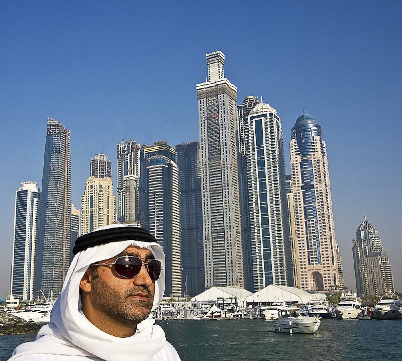 A local Arab man in typical dress rides in a tour boat with the skyline of the city behind him in Dubai, United Arab Emirates. Dubai is the most populous city and emirate in the UAE. The earliest mention of Dubai was in 1095, and a settlement was recorded in 1799. The city was formally established in 1833. Dubai, along with Abu Dhabi and the five other emirates, formed the United Arab Emirates in 1971. Dubai has a population of 2,106,177.
