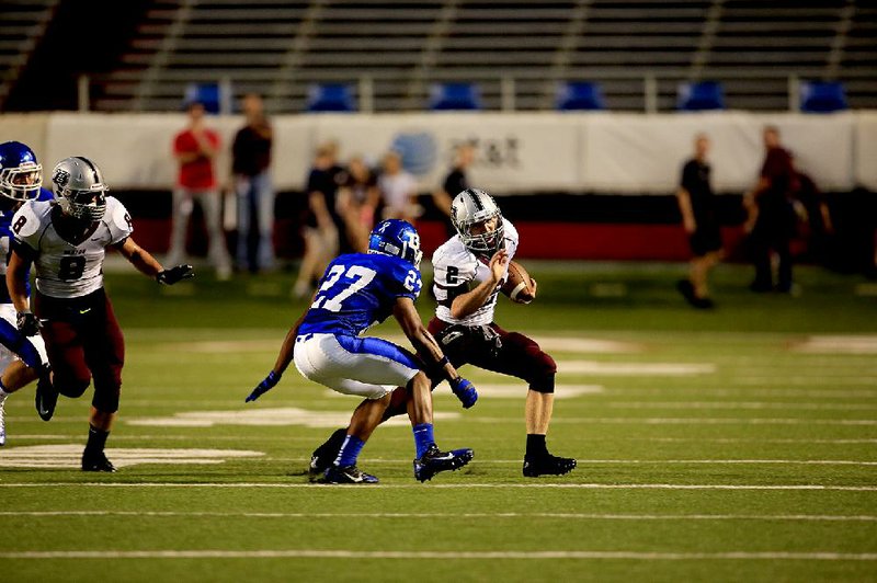 Benton’s Drew Harris (2) tries to run past Bryant defensive back Steven Murdock during the Panthers’ 14-14 tie with the Hornets on Friday at War Memorial Stadium in Little Rock.