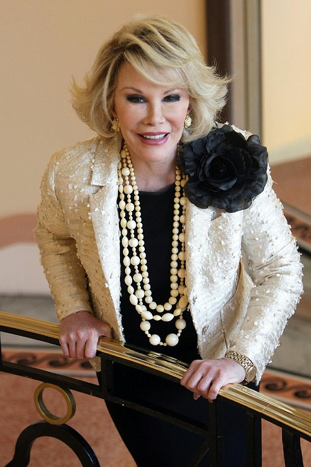 FILE - This Oct. 5, 2009 file photo shows Joan Rivers posing as she presents "Comedy Roast with Joan Rivers " during the 25th MIPCOM (International Film and Programme Market for TV, Video, Cable and Satellite) in Cannes, southeastern France. Rivers, the raucous, acid-tongued comedian who crashed the male-dominated realm of late-night talk shows and turned Hollywood red carpets into danger zones for badly dressed celebrities,  died Thursday, Sept. 4, 2014. She was 81. Rivers was hospitalized Aug. 28, after going into cardiac arrest at a doctor's office.  (AP Photo/Lionel Cironneau, File)