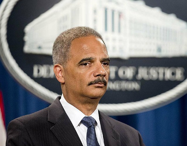 Attorney General Eric Holder takes questions Thursday in Washington during a news conference announcing a broad investigation into the Ferguson, Mo., police operations.