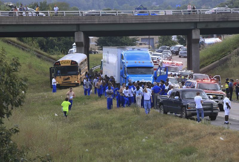 Emergency crews work the scene of a multivehicle accident involving a North Little Rock School District bus on eastbound Interstate 40. The bus was transporting the North Little Rock High School football team, and school officials said there were no injuries. More photos are available at arkansasonline.com/galleries.
