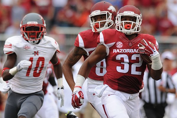 Arkansas running back Jonathan Williams (32) heads to the end zone for a 90-yard touchdown run through the Nicholls defense during the second quarter Saturday, Sept. 6, 2014, at Razorback Stadium in Fayetteville