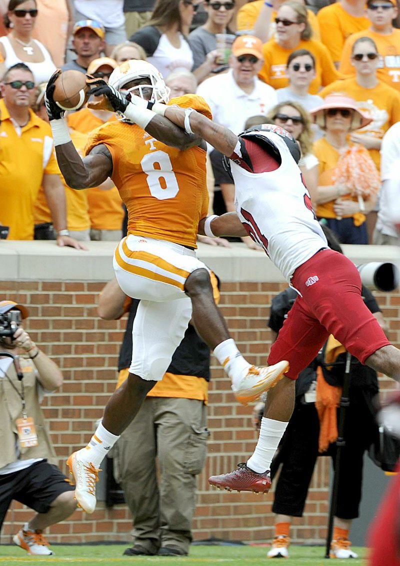 Tennessee wide receiver Marquez North (left) catches a pass from quarterback Justin Worley as Arkansas State defensive back Andrew Tryon tries to break up the play during the second quarter of Saturday’s game at Neyland Stadium in Knoxville, Tenn. North had 4 catches for 68 yards and 2 touchdowns.