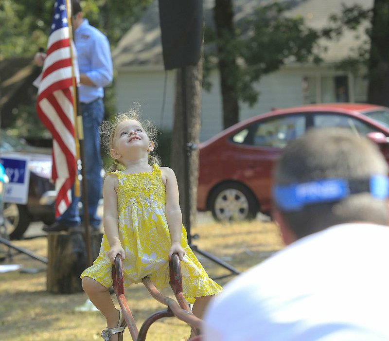  Arkansas Democrat-Gazette/STATON BREIDENTHAL --9/6/14-- Claire Knight (left), 3, plays on the playground with her father, Shane Knight, Saturday morning at the Stand on the Stump political rally in Sherwood. The rally was sponsored by the Sherwood Young Professionals and provided candidates in contested local, Pulaski County and state races the opportunity to speak. 