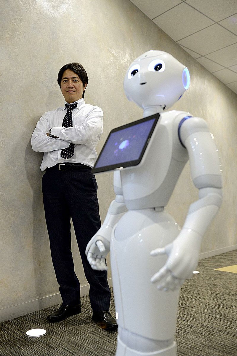 Billionaire Masayoshi Son will start selling his humanoid robots named ìPepperî at Sprint stores in the U.S. by next summer, part of SoftBankís push to take the technology beyond factory floors. Shown, SoftBank Robotics CEO Fumihide Tomizawa with a humanoid robot Monday in Tokyo. Illustrates ROBOTS (category f) by Rin Ichino and Takashi Amano © 2014, Bloomberg News. Moved Tuesday, September 2, 2014. (MUST CREDIT: Bloomberg News photo by Akio Kon).

