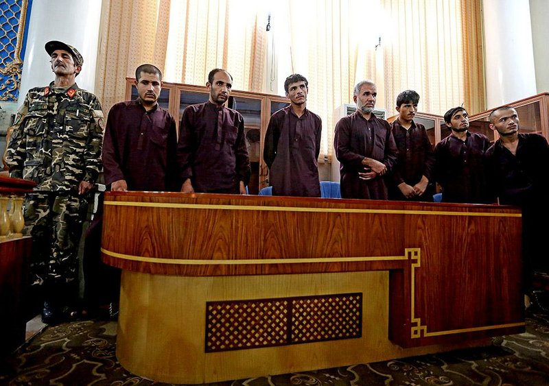 Seven suspects involved in a gang-rape case that took place in Paghman district and has inflamed public anger, attend their trial at a provincial court in Kabul, Afghanistan, Sunday, Sept. 7, 2014. Judges sentenced to death seven Afghan men Sunday in an open trail for kidnapping female passengers, robbing their belongings, and raping them nearly a week ago. (AP Photo/Rahmat Gul)