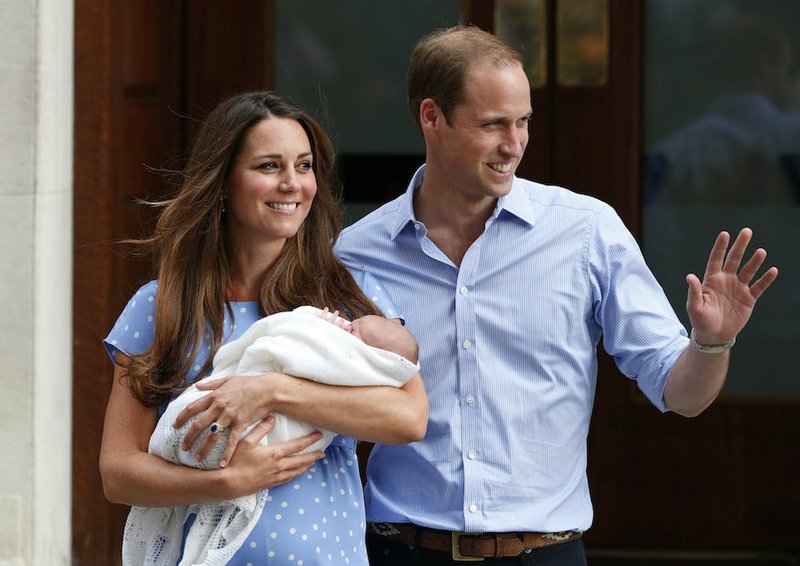 In this Tuesday, July 23, 2013, file photo, Britain's Prince William and Kate, Duchess of Cambridge hold George, the Prince of Cambridge, as they pose for photographers outside St. Mary's Hospital exclusive Lindo Wing in London where the Duchess gave birth on Monday, July 22. The Duchess of Cambridge, wife of Prince William, is expecting her second child and was being treated for severe morning sickness, royal officials said Monday, Sept. 8, 2014. 