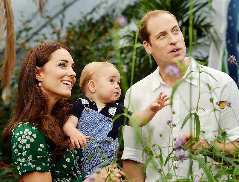 FILE - This photo taken Wednesday, July 2, 2014, and released Monday, July 21, 2014, to mark Prince George's first birthday, shows Britain's Prince William and Kate Duchess of Cambridge and the Prince during a visit to the Sensational Butterflies exhibition at the Natural History Museum, London. The Duchess of Cambridge, wife of Prince William, is expecting her second child and was being treated for severe morning sickness, royal officials said Monday, Sept. 8, 2014.  (AP Photo/John Stillwell, Pool)