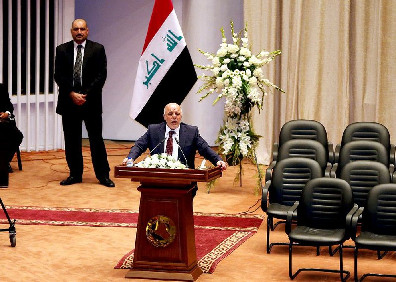 Iraq's new Prime Minister Haider al-Abadi speaks to Iraqi lawmakers before submitting his government in Baghdad, Iraq, Monday, Sept. 8, 2014. Iraq's parliament officially named Haider al-Abadi the country's new prime minister late Monday and approved most of the candidates put forward for his Cabinet amid mounting pressure to form an inclusive government that can collectively cap the advance of Sunni militants. (AP Photo/Karim Kadim)