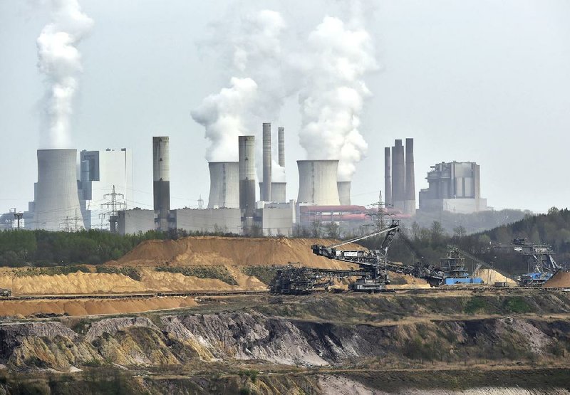 Machines dig for brown coal in front of a puffing power plant near Grevenbroich in western Germany in April. The United Nations reported that developed and developing nations have failed to reach emissions-curb goals.