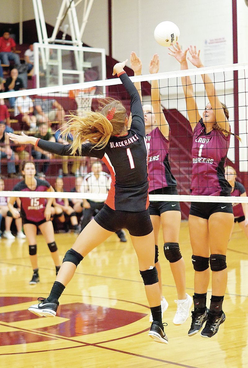Photo by Randy Moll Lauren Little and Sofiya Stasiv attempt to block a ball spiked by Emma Pitts of Pea Ridge during play in Gentry on Sept. 2.