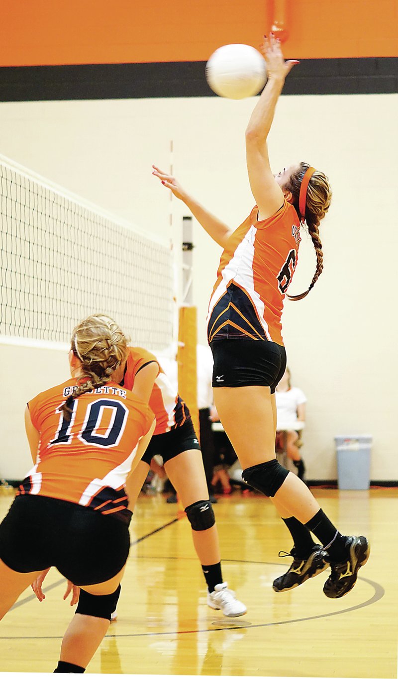 Photo by Randy Moll Katlynn Martin, Gravette senior, spikes the ball across the net during play on Thursday against Prairie Grove at Gravette High School.