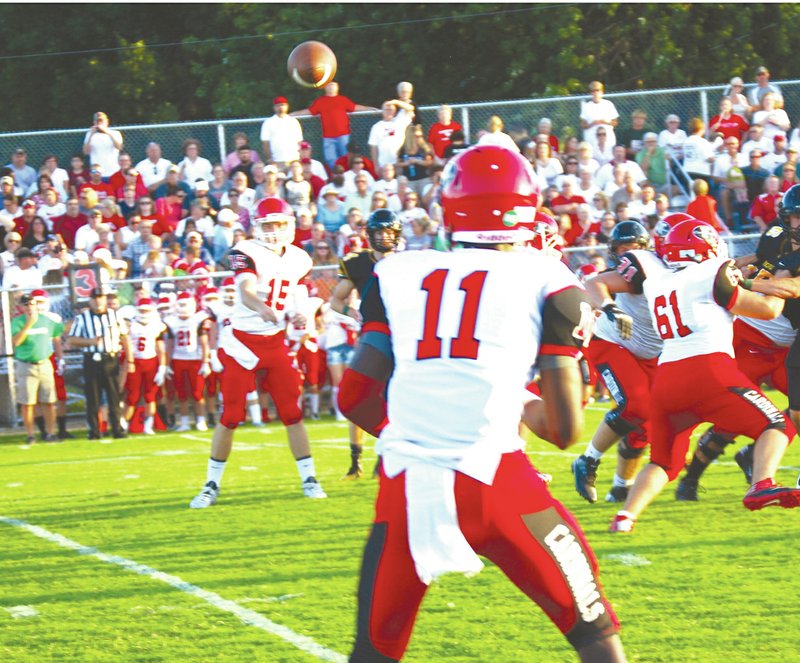 BEN MADRID ENTERPRISE-LEADER Farmington quarterback Brice Waggle throws a pass to receiver Michael Ingram. Ingram led all receivers with 179 yards on 9 receptions including a 61-yard touchdown. The Cardinals beat Prairie Grove, 34-27, on Friday.